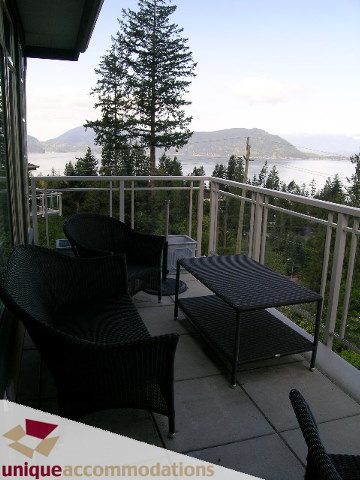 Spacious balcony with a stunning view of the mountains and water, perfect for relaxation. - 8583 Seascape Lane, West Vancouver