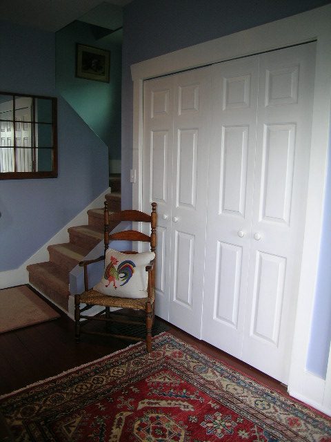 Foyer with white doors, wooden chair, and patterned rug. - 1152 West 7th Ave, Vancouver West Side