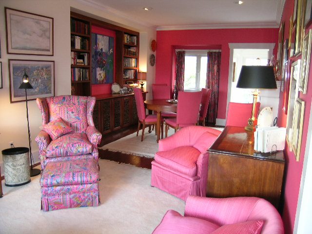 Living room with vibrant pink furniture and artwork, large windows, and a cozy ambiance. - 1152 West 7th Ave, Vancouver West Side