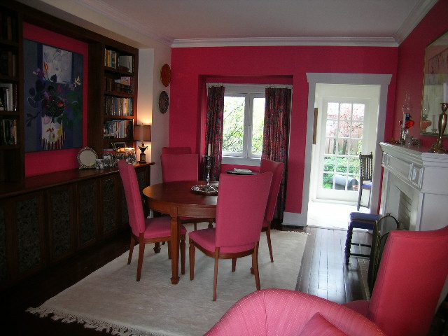 Furnished dining area with pink walls, wooden furniture, and large windows. - 1152 West 7th Ave, Vancouver West Side