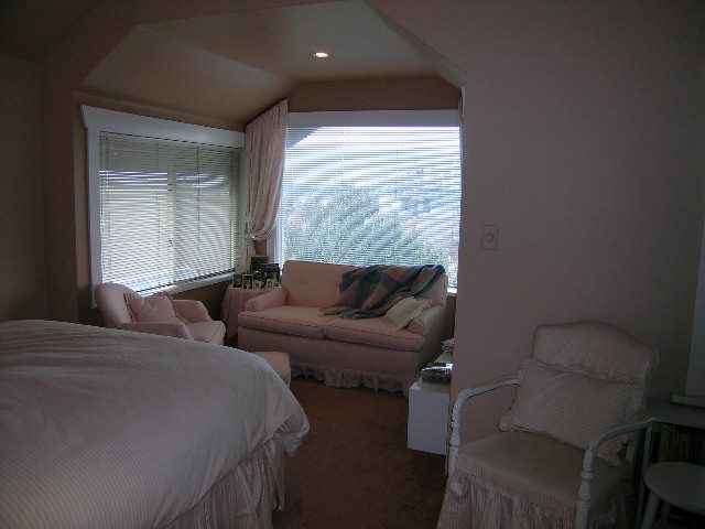 Bright bedroom with large windows and pink furnishings. - 1152 West 7th Ave, Vancouver West Side