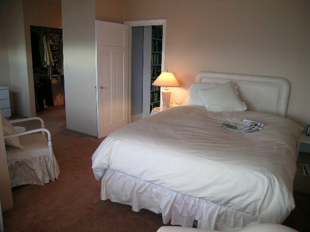 Spacious bedroom with white bedding, nightstand, and lamp. - 1152 West 7th Ave, Vancouver West Side