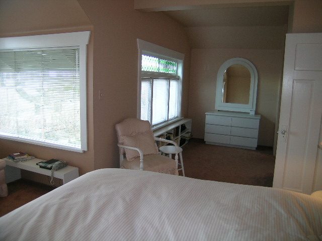 Bright bedroom with white furniture and large windows, allowing natural light. - 1152 West 7th Ave, Vancouver West Side