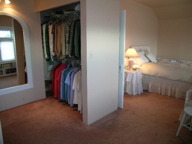 Bright bedroom with neatly made bed, closet, and dresser. - 1152 West 7th Ave, Vancouver West Side