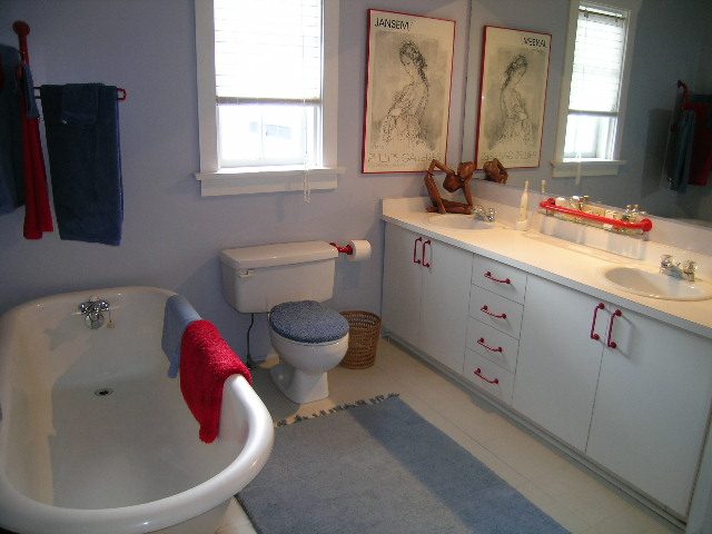 Spacious bathroom with white cabinetry, red accents, and a large bathtub. - 1152 West 7th Ave, Vancouver West Side