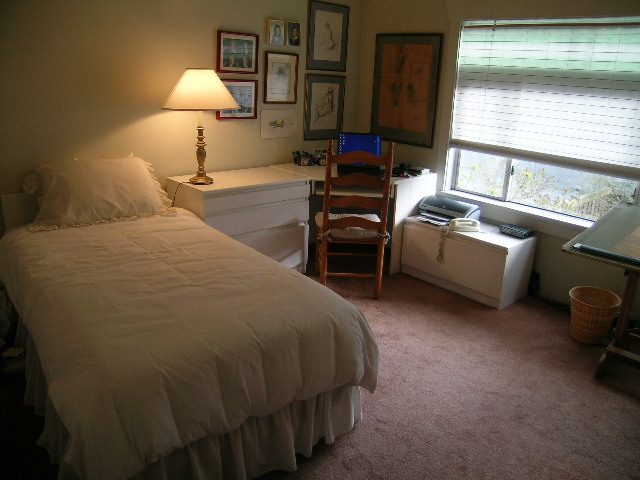 Bright bedroom with a neatly made bed, desk, and window view. - 1152 West 7th Ave, Vancouver West Side