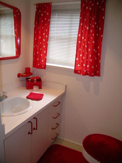 Bright bathroom with red polka-dot curtains and white countertop. - 1152 West 7th Ave, Vancouver West Side