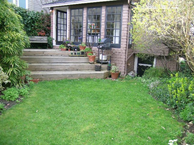 Bright sunroom with large windows, potted plants, and a cozy seating area. - 1152 West 7th Ave, Vancouver West Side