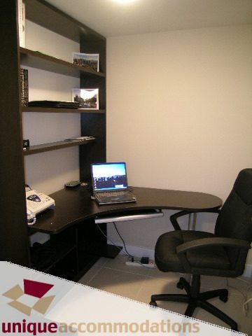 Compact office with a desk, chair, and small computer setup. - 3104 - 1255 Seymour Street, Vancouver Downtown
