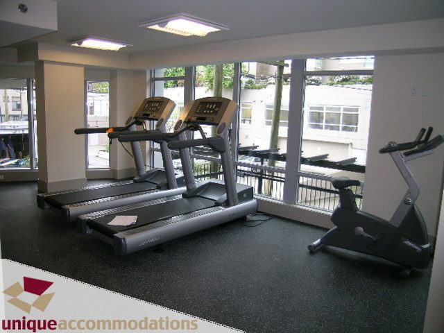 Bright fitness room with treadmills and large windows, city view. - 3104 - 1255 Seymour Street, Vancouver Downtown