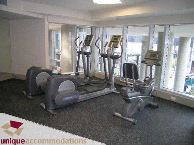 Bright gym with cardio machines and large windows offering city views. - 3104 - 1255 Seymour Street, Vancouver Downtown