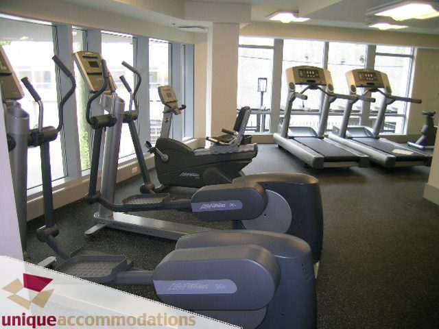 Fitness room with cardio equipment and large windows. - 3104 - 1255 Seymour Street, Vancouver Downtown