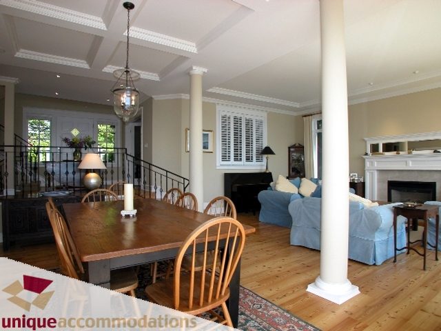 Spacious dining room with coffered ceiling, hardwood floors, and a large wooden table. - 3586 Creery Ave, West Vancouver