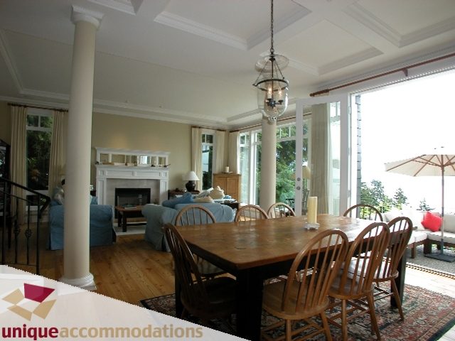 Spacious dining room with coffered ceiling, hardwood floors, and large windows. - 3586 Creery Ave, West Vancouver