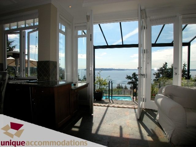 Spacious kitchen with granite countertops and a stunning city view. - 3586 Creery Ave, West Vancouver
