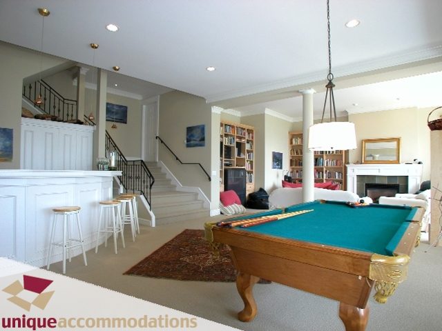 Spacious living room with pool table, bookshelves, and cozy seating area. - 3586 Creery Ave, West Vancouver