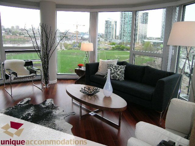 Spacious living room with hardwood floors, modern furniture, and a stunning city view. - 5C - 199 Drake Street, Vancouver Downtown