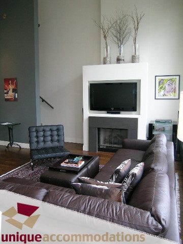 Furnished living room with leather couch, coffee table, and modern decor. - PH2 - 869 Beatty Street, Vancouver Downtown