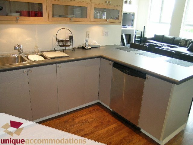 Bright kitchen with sleek countertops, hardwood floors, and a modern design. - PH2 - 869 Beatty Street, Vancouver Downtown