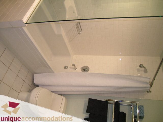 Bright bathroom with glass shower, modern fixtures, and neatly folded towels. - PH2 - 869 Beatty Street, Vancouver Downtown