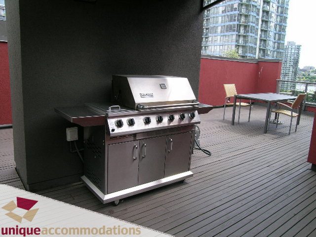Bright patio with outdoor grill and dining set, city view. - PH2 - 869 Beatty Street, Vancouver Downtown