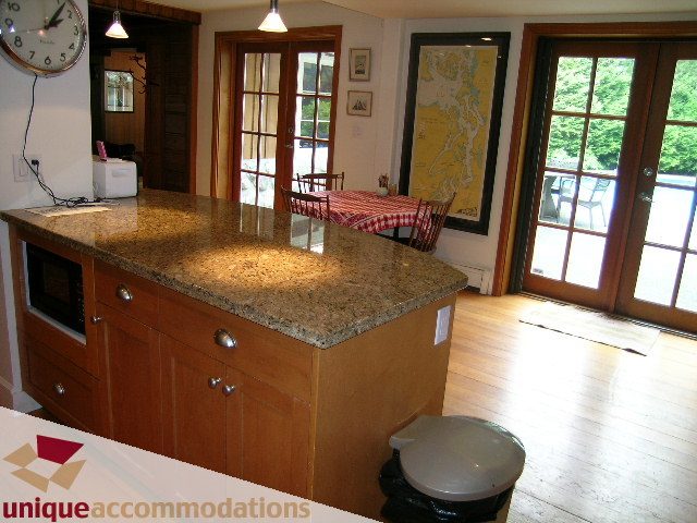 Bright kitchen with granite countertops, hardwood floors, and French doors leading to a garden. - 419 Inglewood ave, West Vancouver