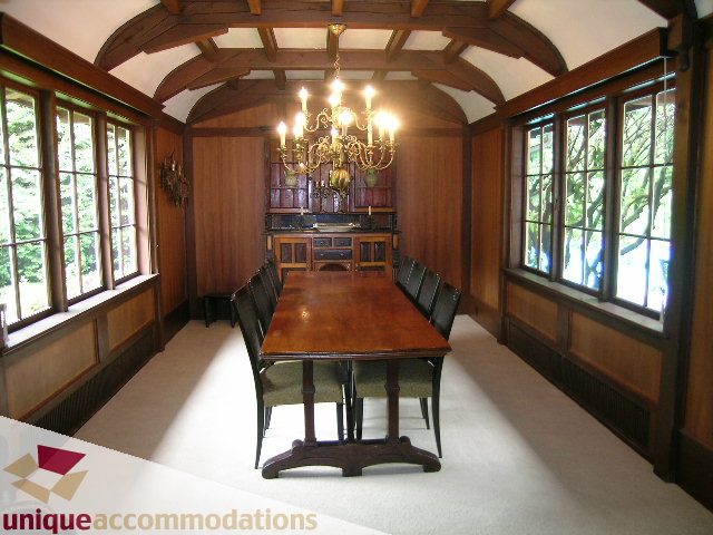 Elegant dining room with arched ceiling, hardwood floors, and large windows. - 419 Inglewood ave, West Vancouver