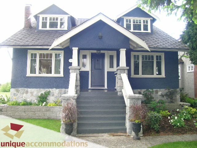 Furnished 5-bedroom suite with dark blue exterior and stone accents. - 1505 Grand Blvd., North Vancouver