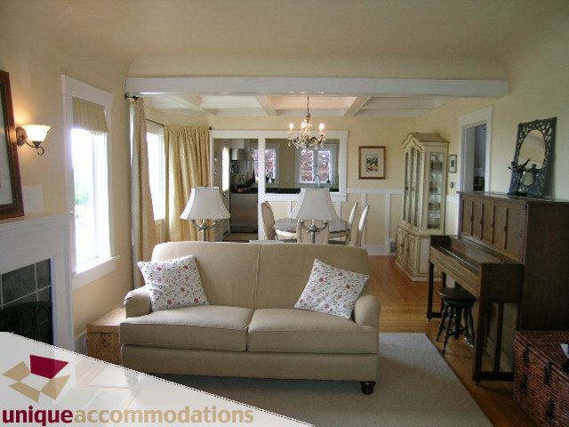 Furnished living room with coffered ceiling, hardwood floors, and large windows. - 1505 Grand Blvd., North Vancouver