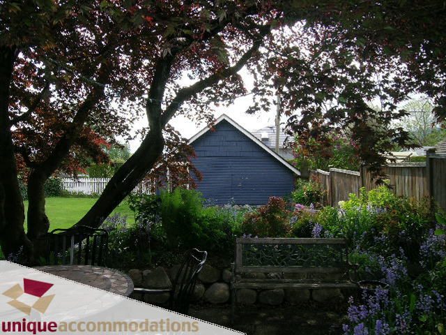 Furnished garden with stone wall and blooming flowers. - 1505 Grand Blvd., North Vancouver