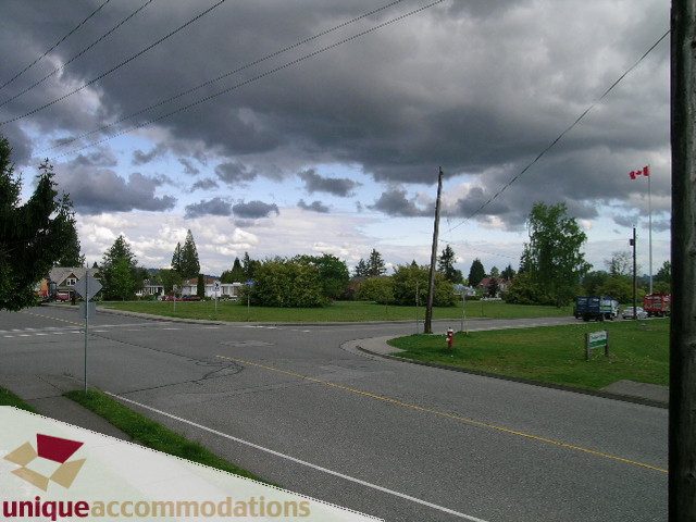 Furnished living room with cozy furniture and large windows. - 1505 Grand Blvd., North Vancouver