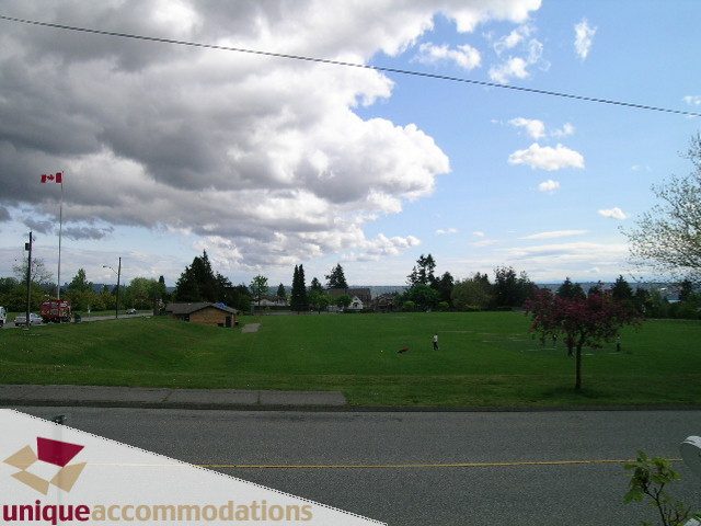 Furnished living room with greenery and a view of the city. - 1505 Grand Blvd., North Vancouver