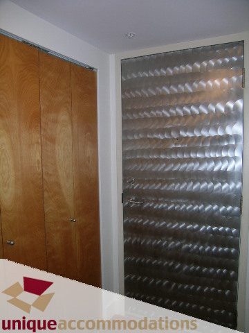 Bright kitchen with wooden cabinets and textured backsplash. - 512-1216 Homer Street, Vancouver Downtown