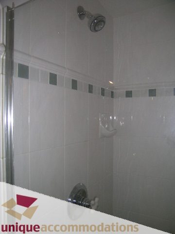 Furnished bathroom with modern showerhead and tiled walls. - 512-1216 Homer Street, Vancouver Downtown