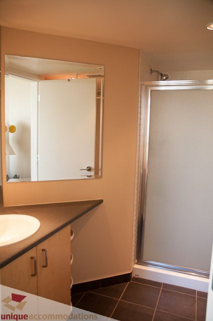 Furnished bathroom with modern sink, mirror, and shower. - 508-155 West 1st Street, North Vancouver