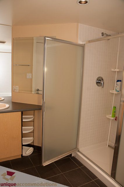 Bathroom with modern shower and sleek countertop. - 508-155 West 1st Street, North Vancouver