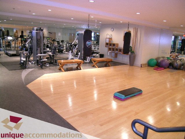 Bright gym with hardwood floors, exercise equipment, and mirrors. - 2001-1199 Seymour Street, Vancouver Downtown