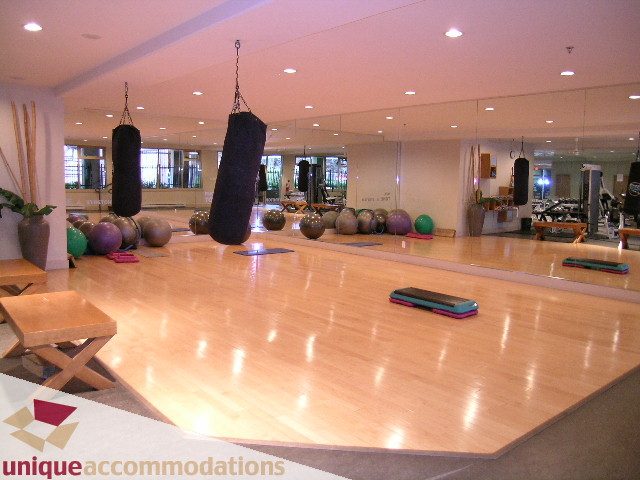 Furnished fitness studio with hardwood floors, exercise equipment, and mirrors. - 2001-1199 Seymour Street, Vancouver Downtown