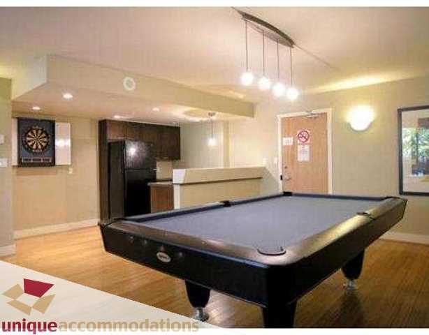 Bright living room with pool table, hardwood floors, and a dartboard. - 2001-1199 Seymour Street, Vancouver Downtown