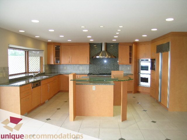 Bright kitchen with modern cabinetry, granite countertops, and stainless steel appliances. - 1472 Camridge Road, West Vancouver
