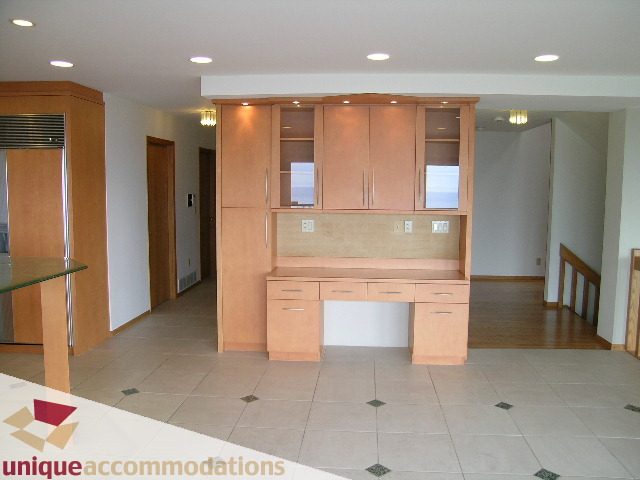 Bright kitchen with light wood cabinets and tiled flooring. - 1472 Camridge Road, West Vancouver