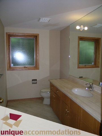 Bathroom with dual sinks, granite countertops, and a frosted window. - 1472 Camridge Road, West Vancouver