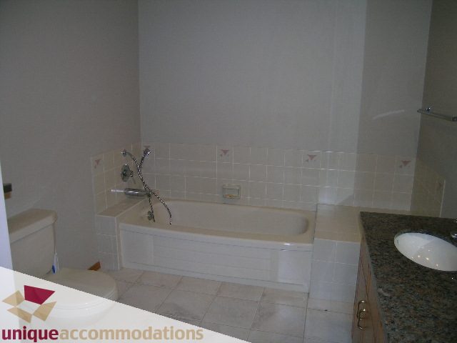 Bathroom with tiled walls, granite countertop, and modern fixtures. - 1472 Camridge Road, West Vancouver