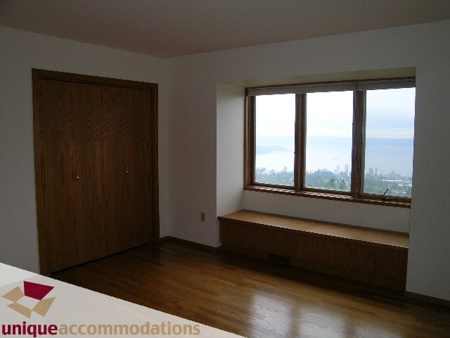 Bright living room with hardwood floors and city view. - 1472 Camridge Road, West Vancouver