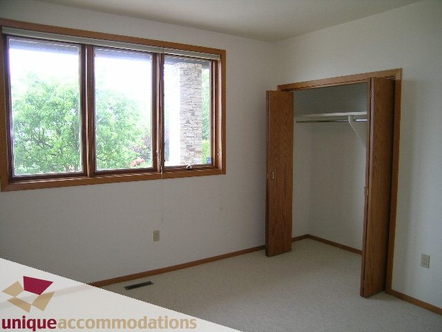 Bright bedroom with large windows and closet access. - 1472 Camridge Road, West Vancouver