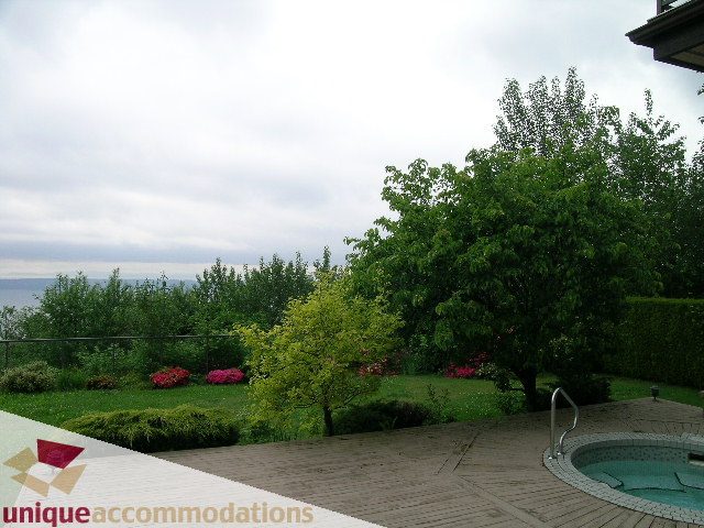 Spacious patio with hot tub and lush garden, overlooking water. - 1472 Camridge Road, West Vancouver