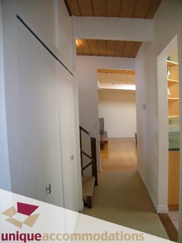 Furnished hallway with wooden ceiling and built-in shelves. - 2556 Belloc Street, North Vancouver