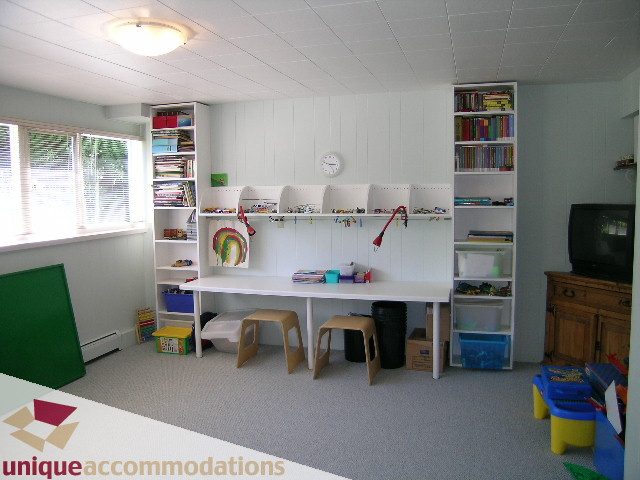 Bright playroom with built-in shelves, books, and toys. - 2556 Belloc Street, North Vancouver