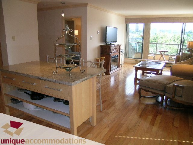 Bright kitchen with granite countertops and hardwood floors, overlooking a city view. - 607 - 1490 Pennyfarthing Drive, Vancouver West Side