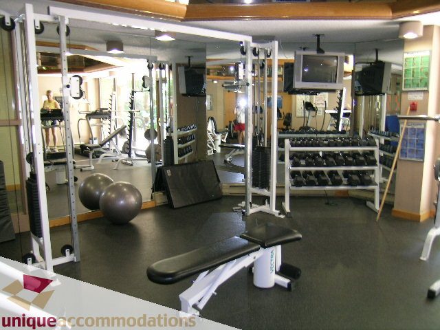 Furnished gym with mirrors, weights, and cardio equipment. - 607 - 1490 Pennyfarthing Drive, Vancouver West Side